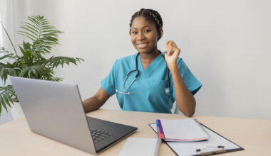Latest remote health jobs concept showing a healthcare professional working on a laptop for a telehealth consultation
