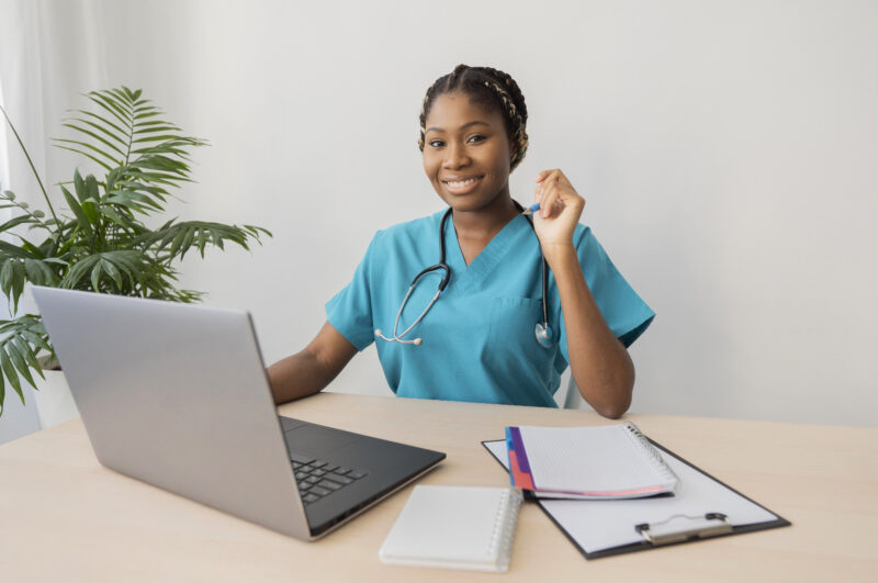 Latest remote health jobs concept showing a healthcare professional working on a laptop for a telehealth consultation