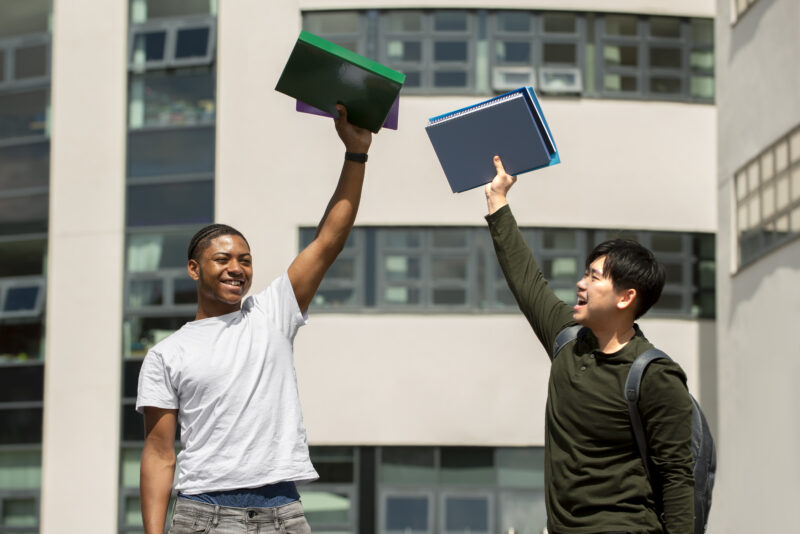 International students celebrating scholarship admission opportunities without IELTS at a university campus