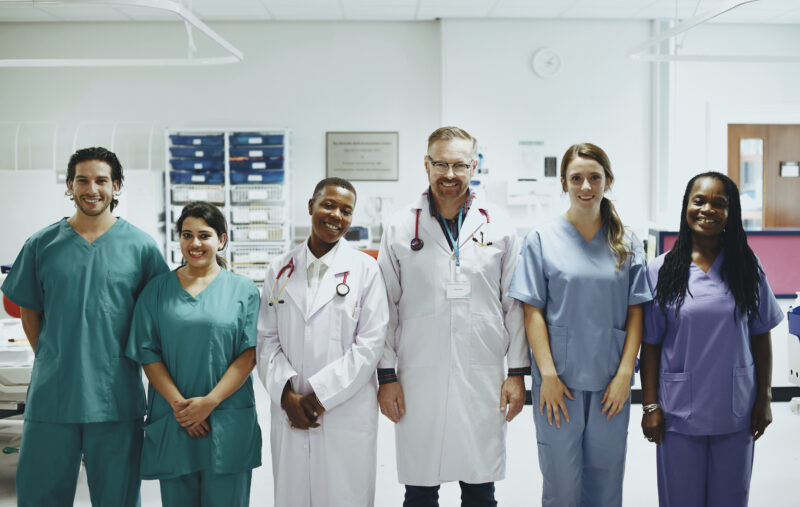 Professional international nurses and healthcare workers standing together in a modern hospital for global nursing career opportunities in 2026