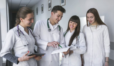 International medical students reviewing academic documents during clinical training while exploring medical scholarships Canada opportunities for international students.