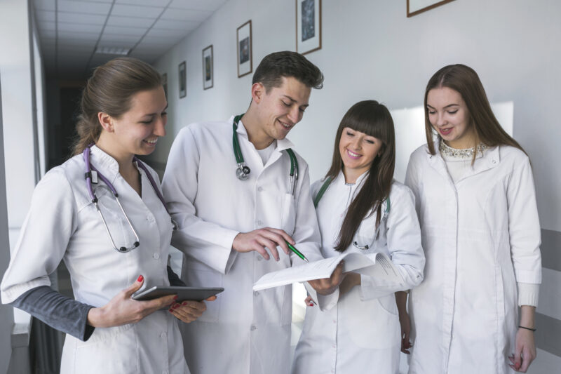 International medical students reviewing academic documents during clinical training while exploring medical scholarships Canada opportunities for international students.