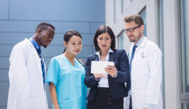Healthcare workers abroad programs featuring international medical professionals reviewing patient information in a modern hospital