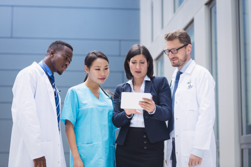 Healthcare workers abroad programs featuring international medical professionals reviewing patient information in a modern hospital