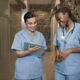 Two registered nurses reviewing patient records in a hospital hallway during clinical practice training