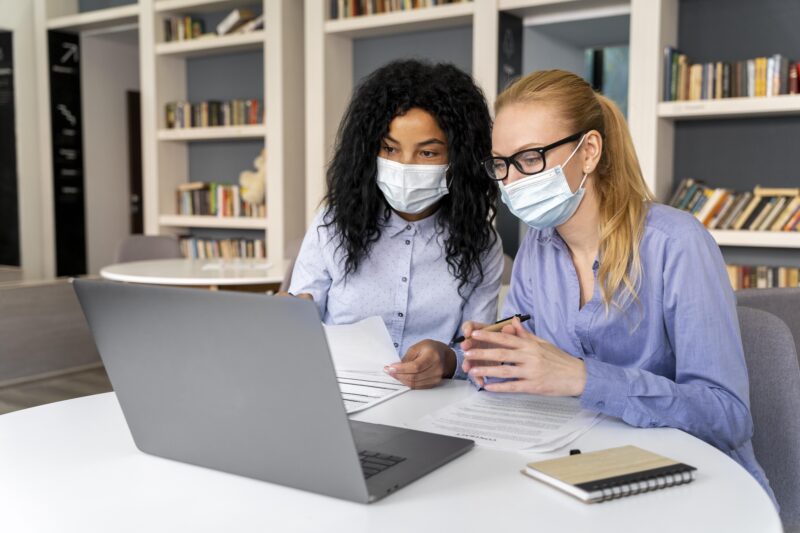 healthcare professionals studying online health certifications on a laptop to advance their healthcare career.