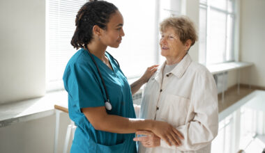 Nursing Assistant Jobs Abroad – healthcare assistant caring for an elderly patient in a modern hospital