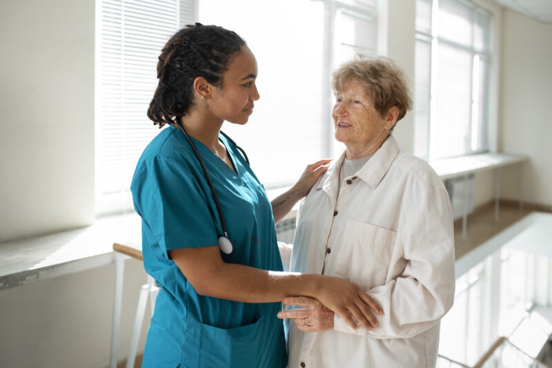 Nursing Assistant Jobs Abroad – healthcare assistant caring for an elderly patient in a modern hospital