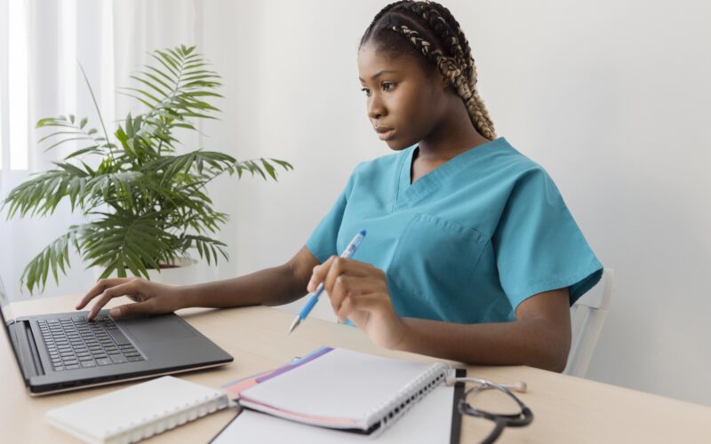 A healthcare professional building a Healthcare LinkedIn Profile on a laptop for better job opportunities
