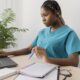 A healthcare professional building a Healthcare LinkedIn Profile on a laptop for better job opportunities